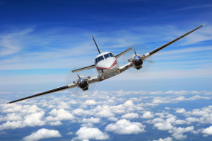 Corporate airplane in flight high above the clouds