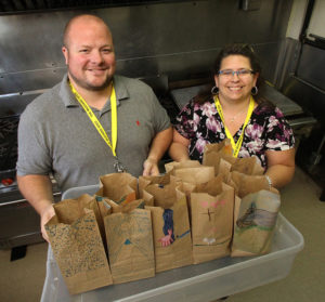 The Mustard Seed's Director of Central Alberta Byron Bradley and Volunteer Resources Coordinator Cori Capner with lunches destined for a local school.