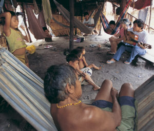 During an afternoon visit with one family, Isaac and Sh irley Souza share a whorship song they translated into the villagers' mother tongue. (Photo by Alan Hood)